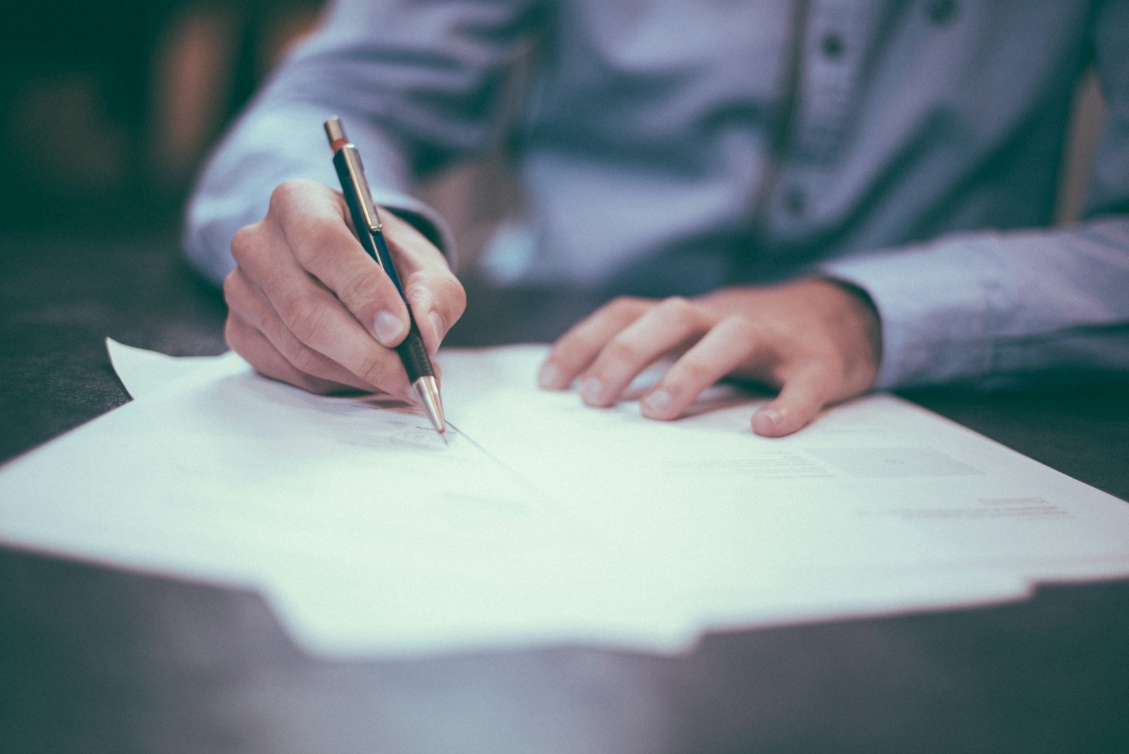 Property papers and a pen on a desk