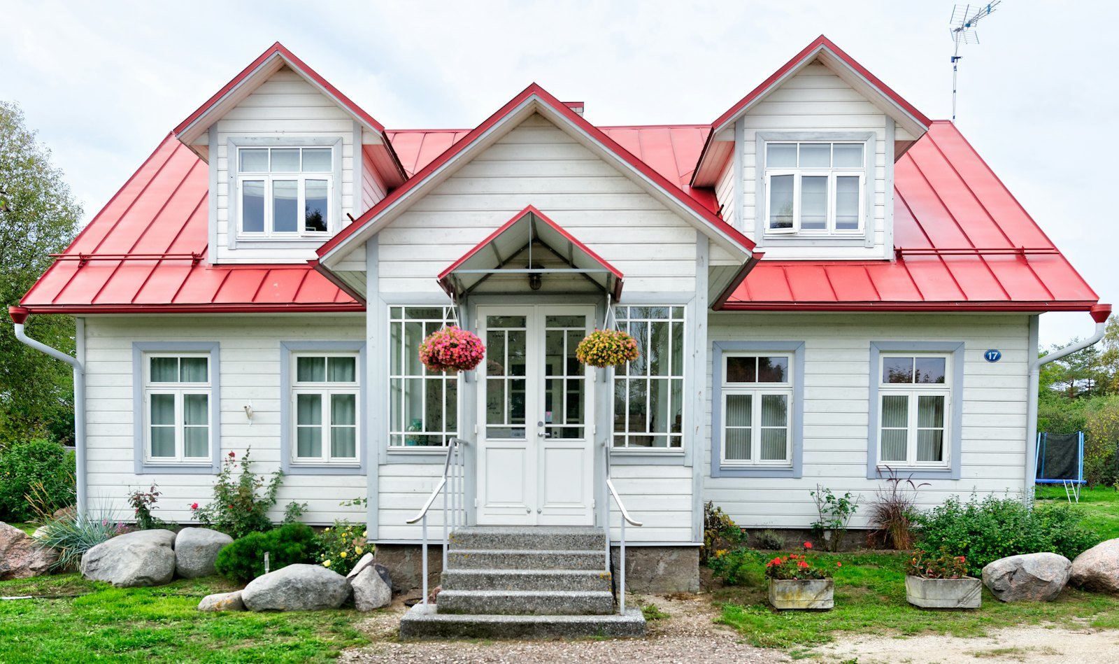 Garden villa with a covered porch and mature trees
