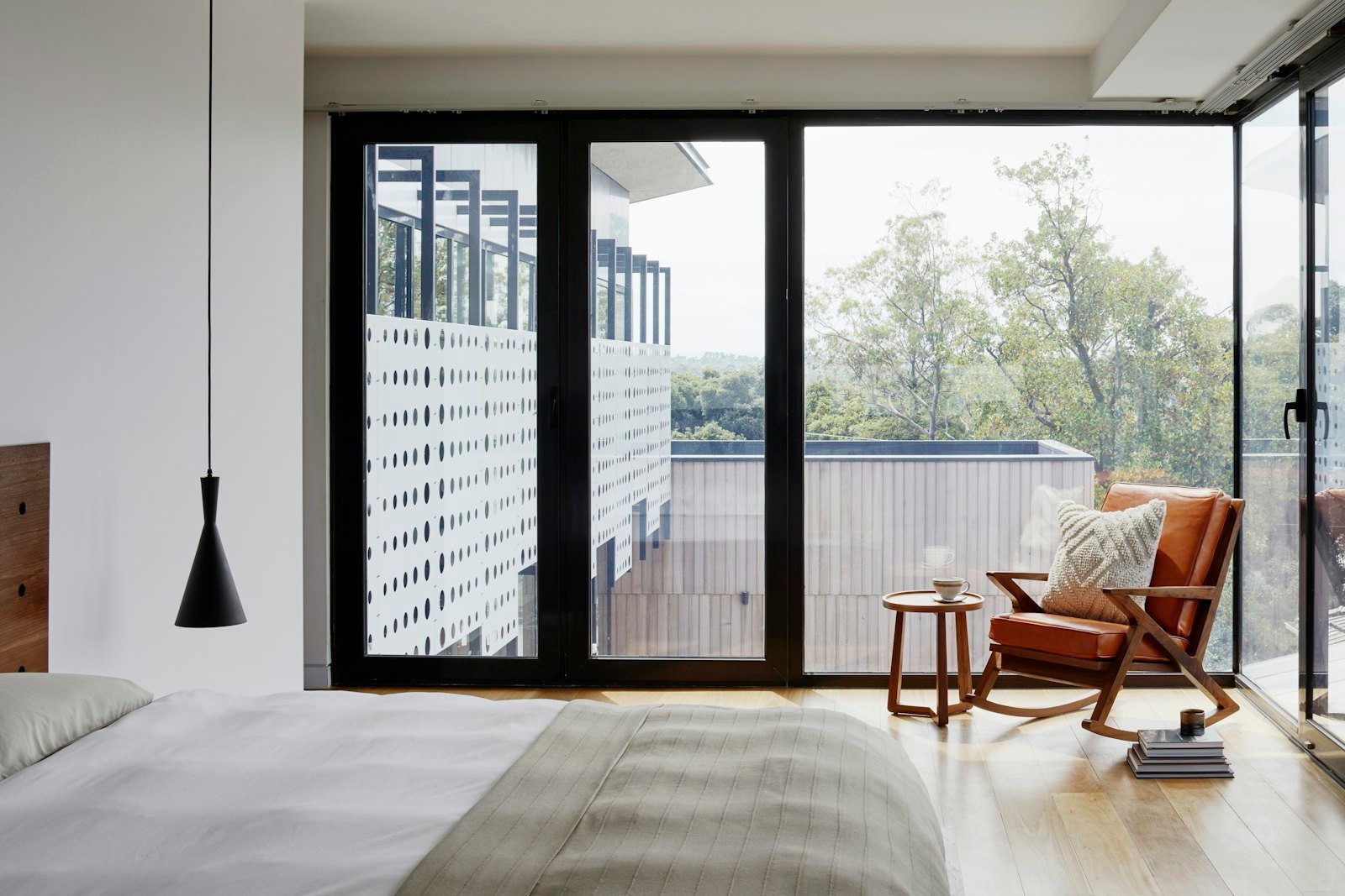 Glass-walled lakeside home with a terrace and pool